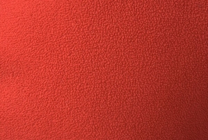 A close-up view of a swatch of red polar fleece.