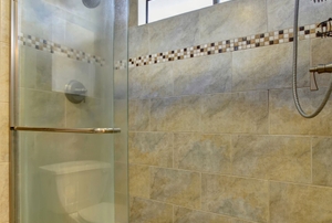 Sliding glass doors on a tiled shower.
