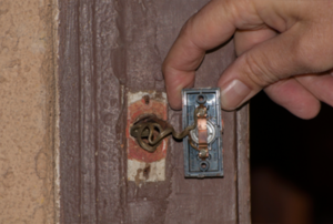 Person removing a doorbell button