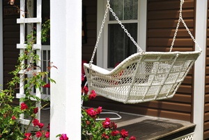 white wicker porch swing