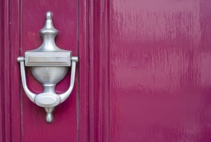 burgundy colored door with silver door knocker