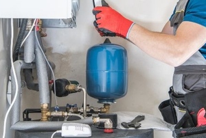man installing gas furnace