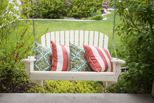 White porch swing with pillows