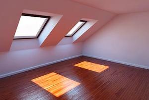 Windows casting light on the floor in a finished attic.