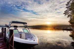 Boat at dock with sunset in the background