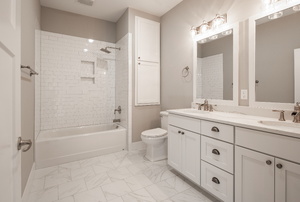 White bathroom with double sinks and two mirrors