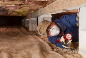 person with a mask in a crawlspace