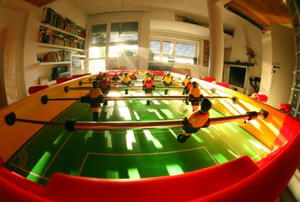 A foosball table stands ready in the gameroom.