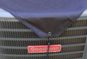 an outside AC condenser with a cover on it