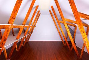 A finished attic with empty storage shelves.
