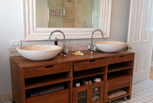 a vanity dresser with double sink and mirror