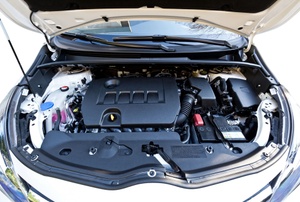 A car with the hood up exposing the engine.
