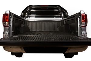 The bed of a silver truck with the tailgate down.