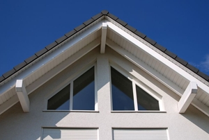 A roofline with a soffit and windows.