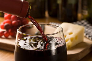 Wine pour with cheese and grapes