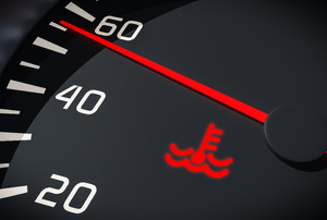 A lit up coolant indicator on a speedometer.
