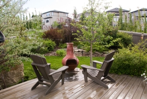 A clay chiminea on a wood deck.