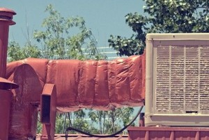 an evaporative cooler system on a roof