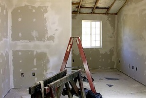 a room with drywall, tape, and mud walls