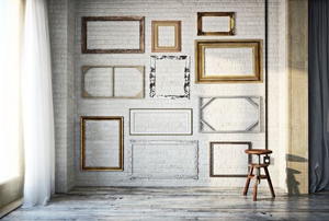 A wall full of vintage picture frames.
