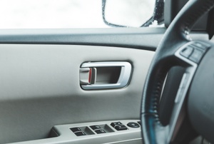 A steering wheel and an interior door lock of a car.