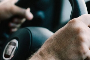 two hands holding a steering wheel