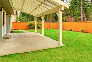 backyard with concrete patio and grass