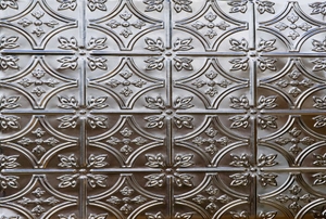 An ornately-pattern, tin background.