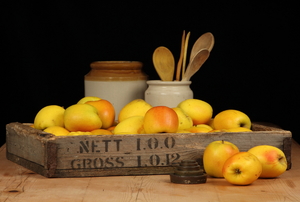 A rustic wood crate with apples. 