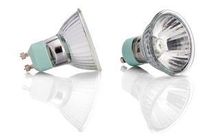 Two halogen light bulbs on a reflective white surface.