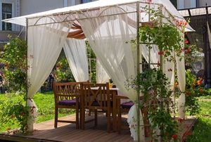 A gazebo with curtains.