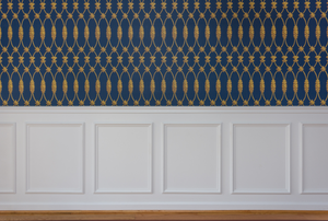 blue and gold wallpaper above waincotting on a wall