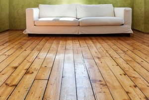 white couch in a room with reclaimed wood flooring