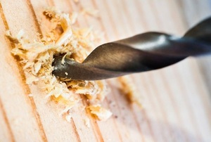 drill bit going into wood stud