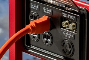 extension cord plug connected to a portable generator