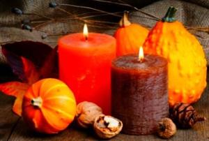 A cluster of Thanksgiving gourds and candles.