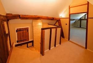 On the landing of a converted attic space in an old farmhouse.