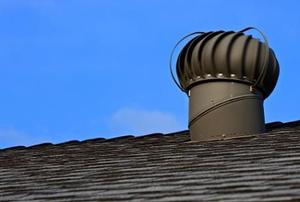 A turbine vent on top of a roof.