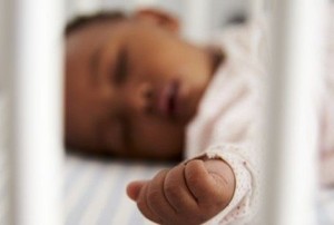 a baby sleeping in a crib