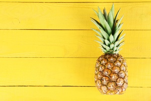 A pineapple on a yellow background.