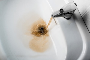 Brown water flowing from a faucet