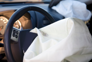 An airbag coming out of a steering wheel.