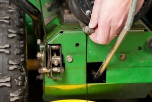 Draining the oil from a snow blower.