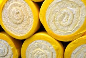 An end-on, close-up view of white rolls of fiberglass insulation material.