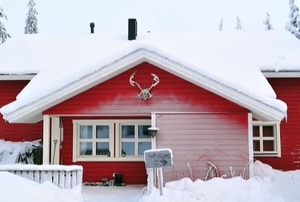 red house in winter covered in snow