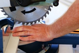 An accident about to happen on a miter saw.