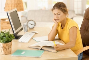 A woman studying at a desk.