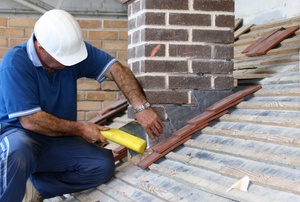 A man works with metal flashing.