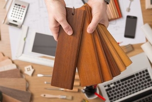 hands holding design wood samples
