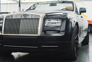 black car parked in clean garage with shiny painted floor
